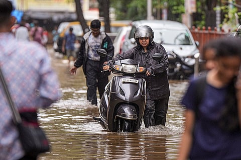 Commuters on a waterlogged road